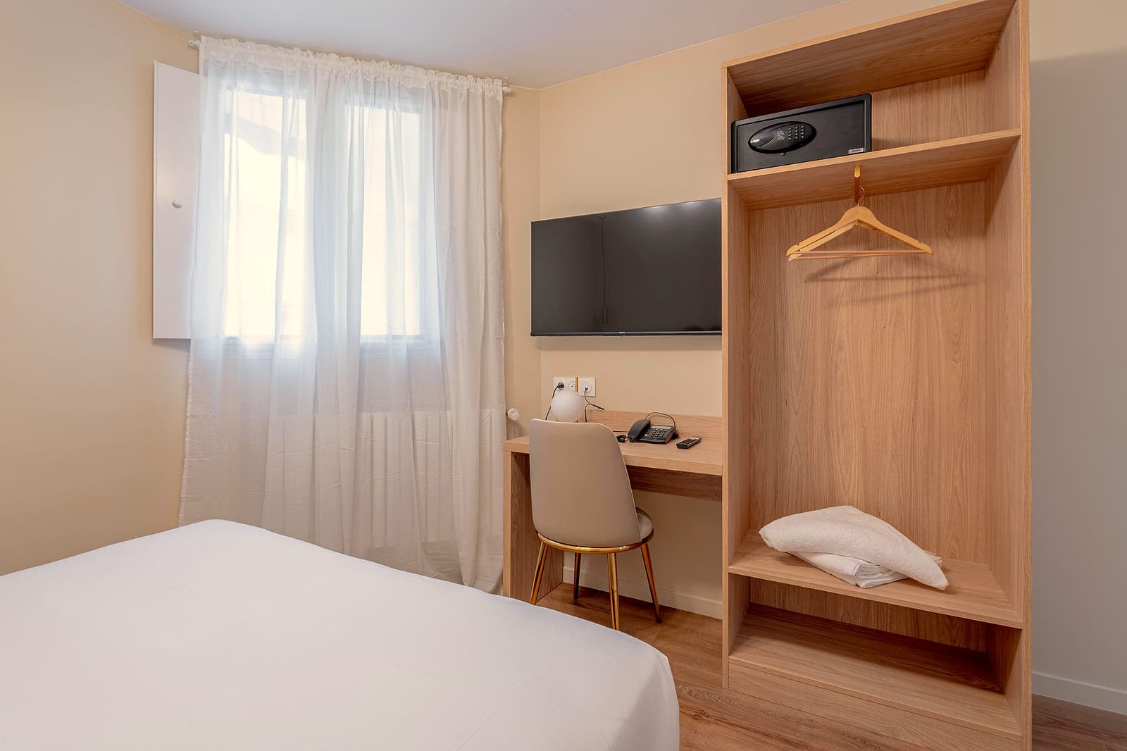 Bureau, Smart TV et penderie d'une chambre Sénia